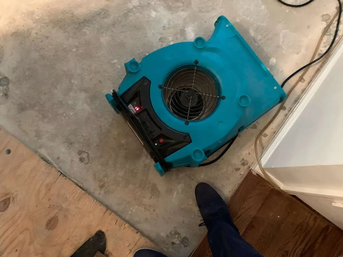Air mover drying subfloor during Commercial Water Damage Restoration in Alafaya